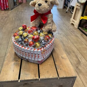 Heart shaped ferro Roche and Lindor cochair with cuddly dog
