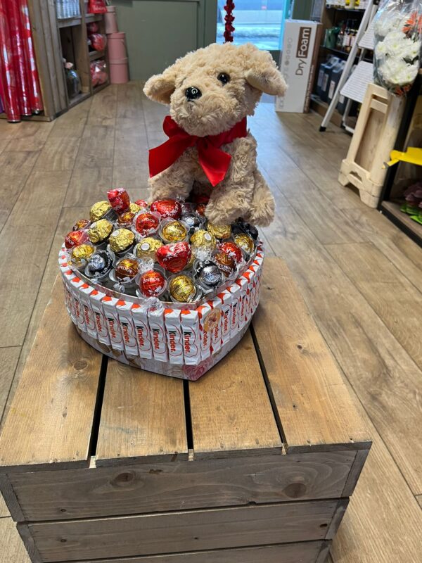 Heart shaped ferro Roche and Lindor cochair with cuddly dog